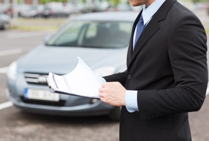 man with car documents outside