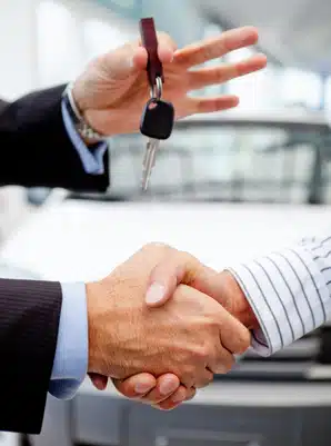 Handshake after buying a car and handling keys